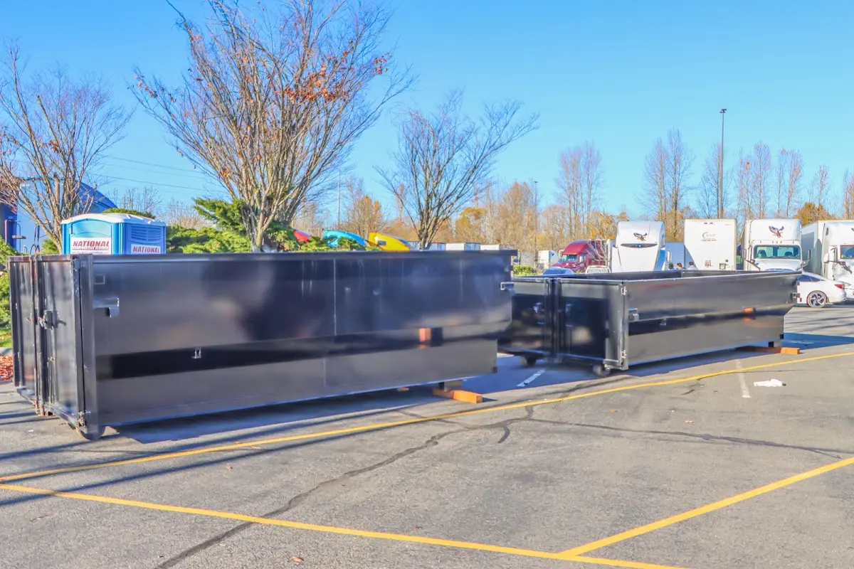 Professional dumpster rental service with roll-off container on residential driveway in Mount Kisco